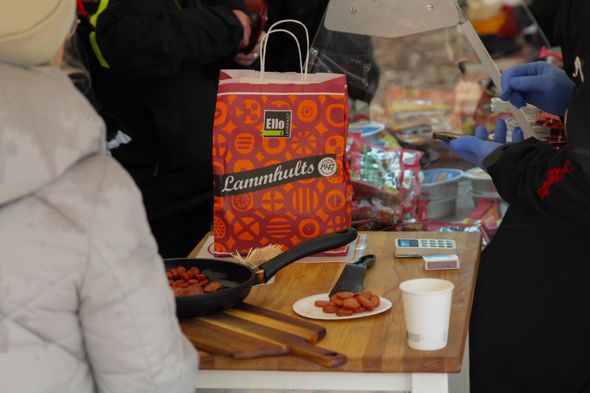 En röd påse och korv på ett bord